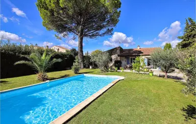 a swimming pool in the yard of a house at Lovely Home In Cheval-Blanc in Cheval-Blanc