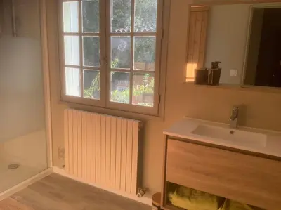 a bathroom with a sink and a window at Le chant de la sorgue in LʼIsle-sur-la-Sorgue