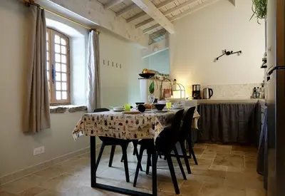 a dining room with a table and chairs at La Grisonne - Gîte Nordine in Revest-du-Bion