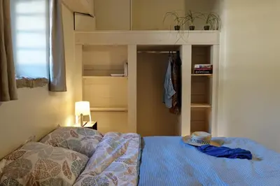 a bedroom with a bed and a bunk bed with a hat on it at La Grisonne - Gîte Nordine in Revest-du-Bion