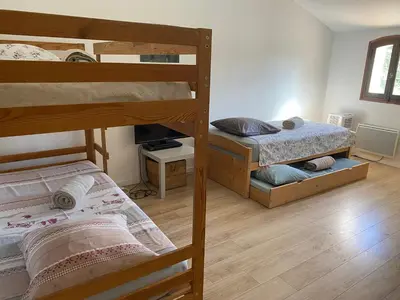 a bedroom with two bunk beds in a room at Le domaine de Gaïa in Aix-en-Provence