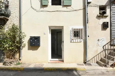 a building with a door and a window at Studio Garrigue in La Fare-les-Oliviers