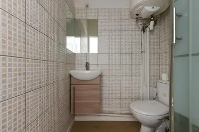 a bathroom with a toilet and a sink and a mirror at Studio Garrigue in La Fare-les-Oliviers
