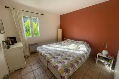 a bedroom with a bed and a window at House quiet and wooded in Aix-en-Provence