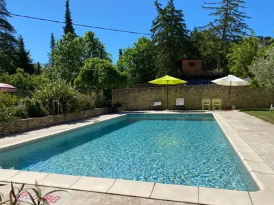 a swimming pool in the backyard of a house at Gîte La loge 142 route de CARPENTRAS 84210 VENASQUE in Venasque