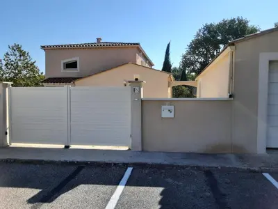 a white fence in front of a house at very pleasant villa with private swimming pool, in a residential area near the center of saint-rémy-de-provence - 8 people in Saint-Rémy-de-Provence