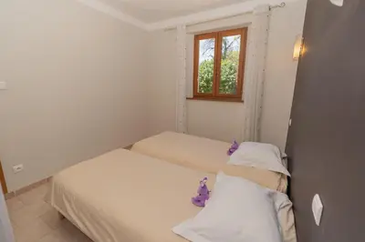 two beds in a small room with a window at Mon Ventoux - Cozyhotes in Sault-de-Vaucluse