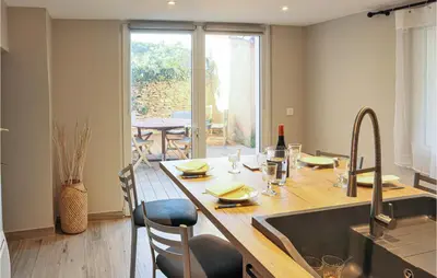 a kitchen with a large wooden table with a sink at Stunning Apartment In Villes Sur Auzon in Villes-sur-Auzon