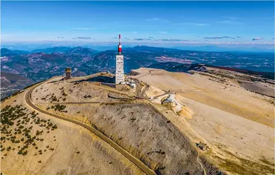 a mountain with a red and white tower on it at Stunning Apartment In Villes Sur Auzon in Villes-sur-Auzon