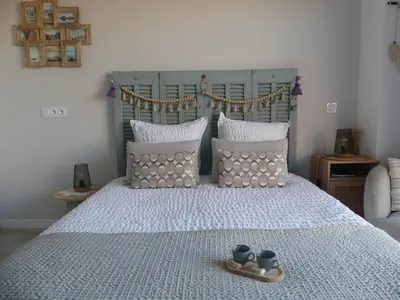 a bedroom with a large bed with two cups on it at Studio Nuitée en Provence 2 in Aix-en-Provence