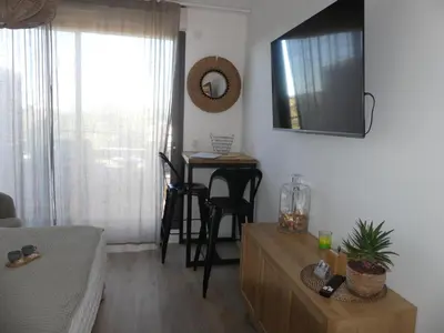 a living room with a table and chairs and a mirror at Studio Nuitée en Provence 2 in Aix-en-Provence