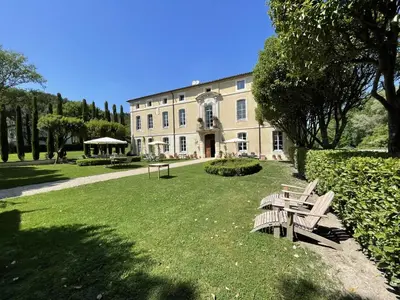 a group of benches in front of a building at Chateau Talaud in Loriol-du-Comtat