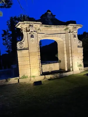 an old building with a window in the grass at Chateau Talaud in Loriol-du-Comtat