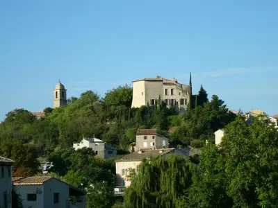 a castle on top of a hill with houses at Mas Boudeissoun - Cœur de cerise - Baignade à 600 m in Mormoiron