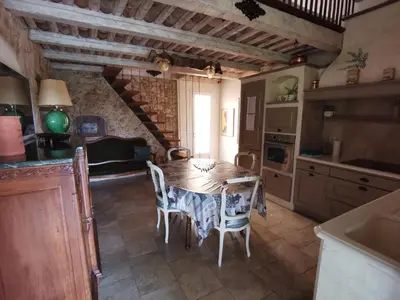 a kitchen with a table and chairs in a room at Gîte la Saume in Lambesc