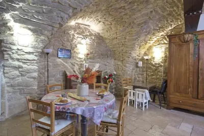 a dining room with a table and chairs and a stone wall at La Mauricette - free Parking & Cancellation - WiFi in Pélissanne