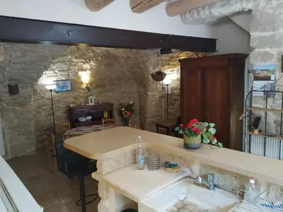 a kitchen with a sink in a stone wall at La Mauricette - free Parking & Cancellation - WiFi in Pélissanne