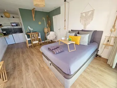 a bedroom with a bed with a table on it at 107 Paisible et unique avec terrasse sur vue piscine in Éguilles