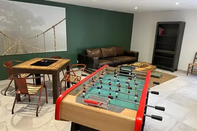 a living room with a table with a foosball at Mas Sylvie - Isle-sur-la-Sorgue in LʼIsle-sur-la-Sorgue