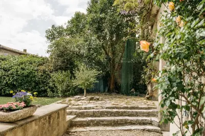a garden with a stone path and a tree at Villa Balleti - private pool with a view in Apt