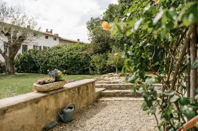 a garden with stairs and flowers in a pot at Villa Balleti - private pool with a view in Apt