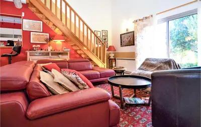 a living room with a couch and a table at Gorgeous Home In Eyragues in Eyragues