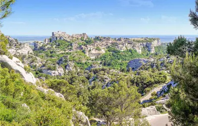 a view of a mountain with a castle on top at Gorgeous Home In Eyragues in Eyragues
