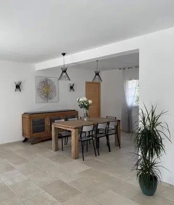 a dining room with a wooden table and chairs at La Bastide Cezanne Natural elegance in Aix-en-Provence