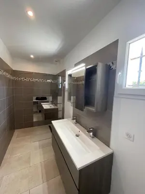 a bathroom with a white sink and a mirror at La Bastide Cezanne Natural elegance in Aix-en-Provence