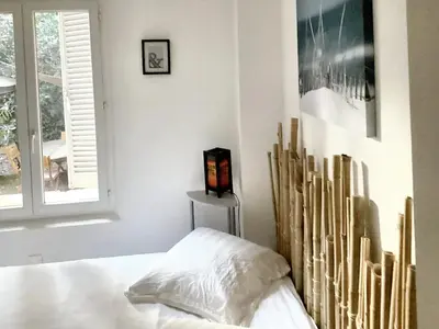 a white bedroom with a bed and a window at Appartement spacieux à Aix-en-Provence 100 m² avec hammam in Aix-en-Provence