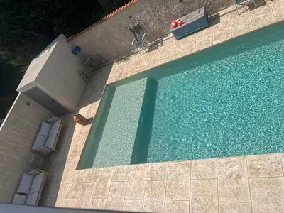 an overhead view of a swimming pool with chairs at Haut de villa avec piscine privée et extérieur in Lançon-Provence