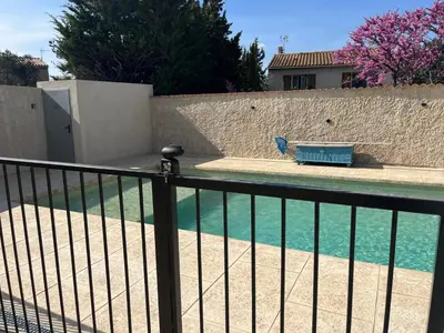 a balcony with a fence and a pool of water at Haut de villa avec piscine privée et extérieur in Lançon-Provence
