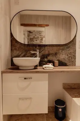 a bathroom with a sink and a mirror at L'Olivier in Mormoiron