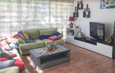 a living room with a couch and a television at 3 Bedroom Cozy Home In Meyrargues in Meyrargues
