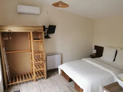 a bedroom with a bed and a ladder next to a bed at Studio indépendant à 2 minutes du golf du Luberon in Pierrevert