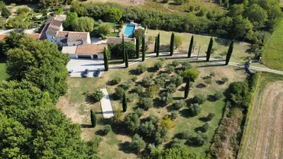 an aerial view of a mansion with cypress trees at Le Mas des Perrines Maison d’Hôtes in Pernes-les-Fontaines