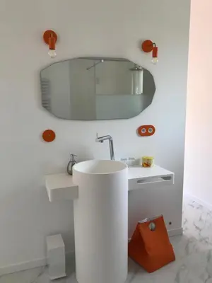 a bathroom with a white sink and a mirror at La Maison 1440 in LʼIsle-sur-la-Sorgue