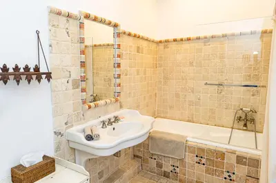 a bathroom with a sink and a bath tub at Maison Bournissac in Noves