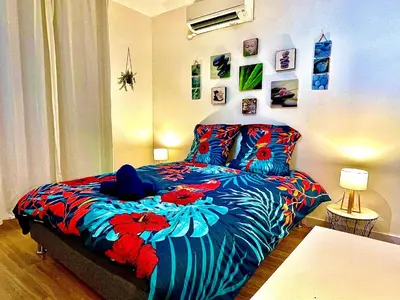 a bedroom with a bed with flowers on it at *Le Namasté*Fibre Wifi*Hyper Centre* in Salon-de-Provence