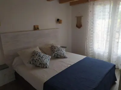 a bed with two pillows on it in a bedroom at Le Petit Pied à Terre du Luberon in Mérindol