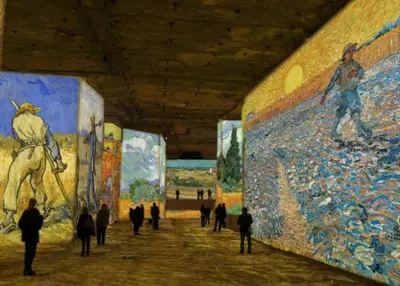 a group of people walking through a museum with paintings at Le Petit Pied à Terre du Luberon in Mérindol