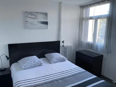 a bedroom with a bed with two pillows and a window at Appartement proche centre ville in Aix-en-Provence