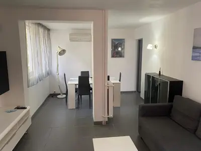a living room with a couch and a table at Appartement proche centre ville in Aix-en-Provence