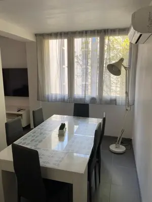 a dining room table with chairs and a floor lamp at Appartement proche centre ville in Aix-en-Provence