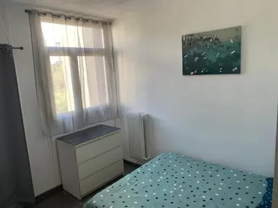 a small bedroom with a bed and a window at Appartement proche centre ville in Aix-en-Provence