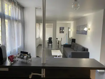 a living room with a couch and a table at Appartement proche centre ville in Aix-en-Provence