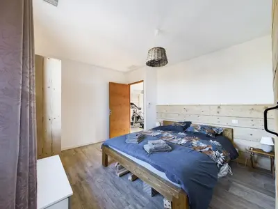 a bedroom with a bed with a blue comforter at Mas des Oliviers in Eyragues