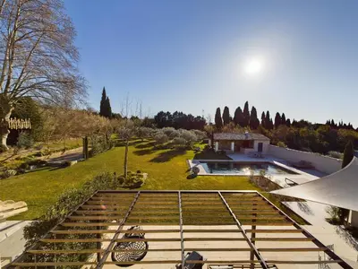 a house with a view of a garden and a house at Mas des Oliviers in Eyragues