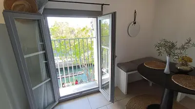 a room with a sliding glass door with a balcony at Vue imprenable sur la Sorgue in LʼIsle-sur-la-Sorgue