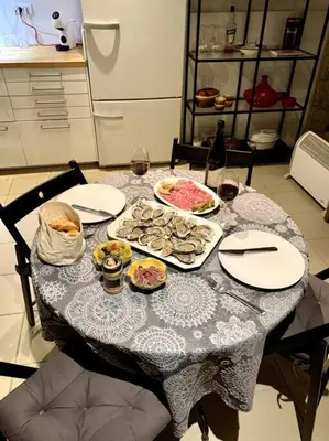 a table with plates of food and glasses of wine at La Petite Cave in Saignon